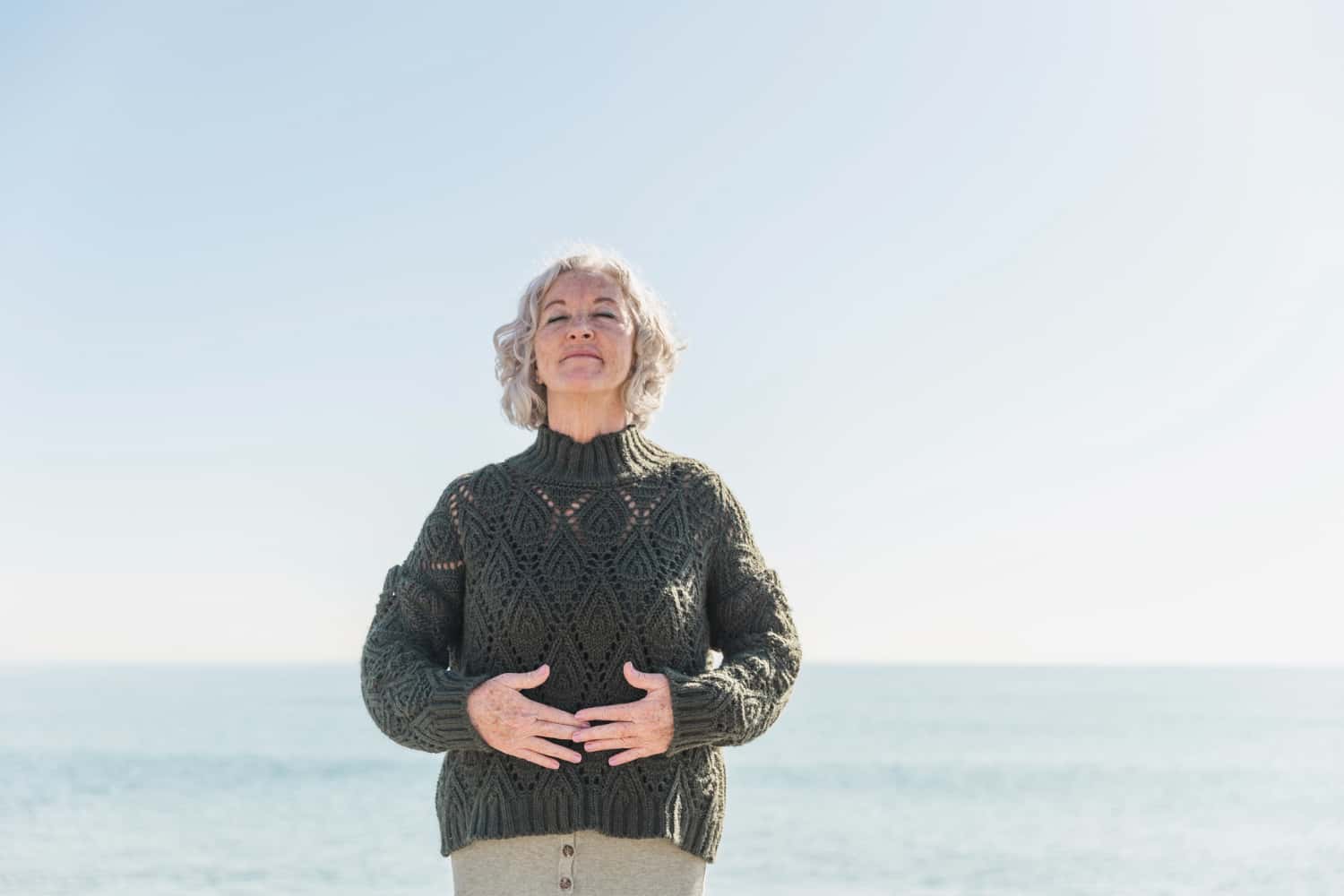 Middle aged woman touching her belly