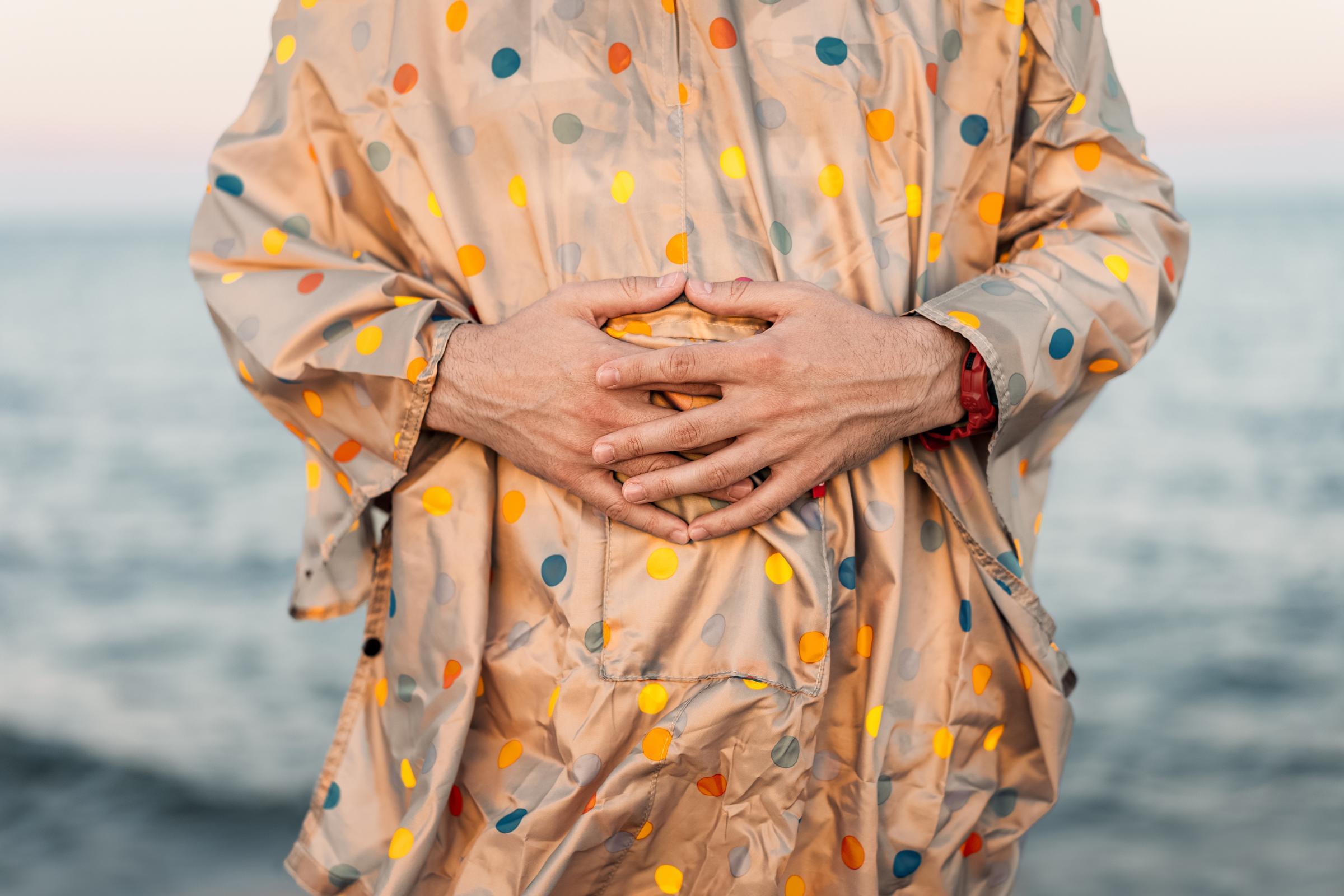 Hands placed on a woman's belly
