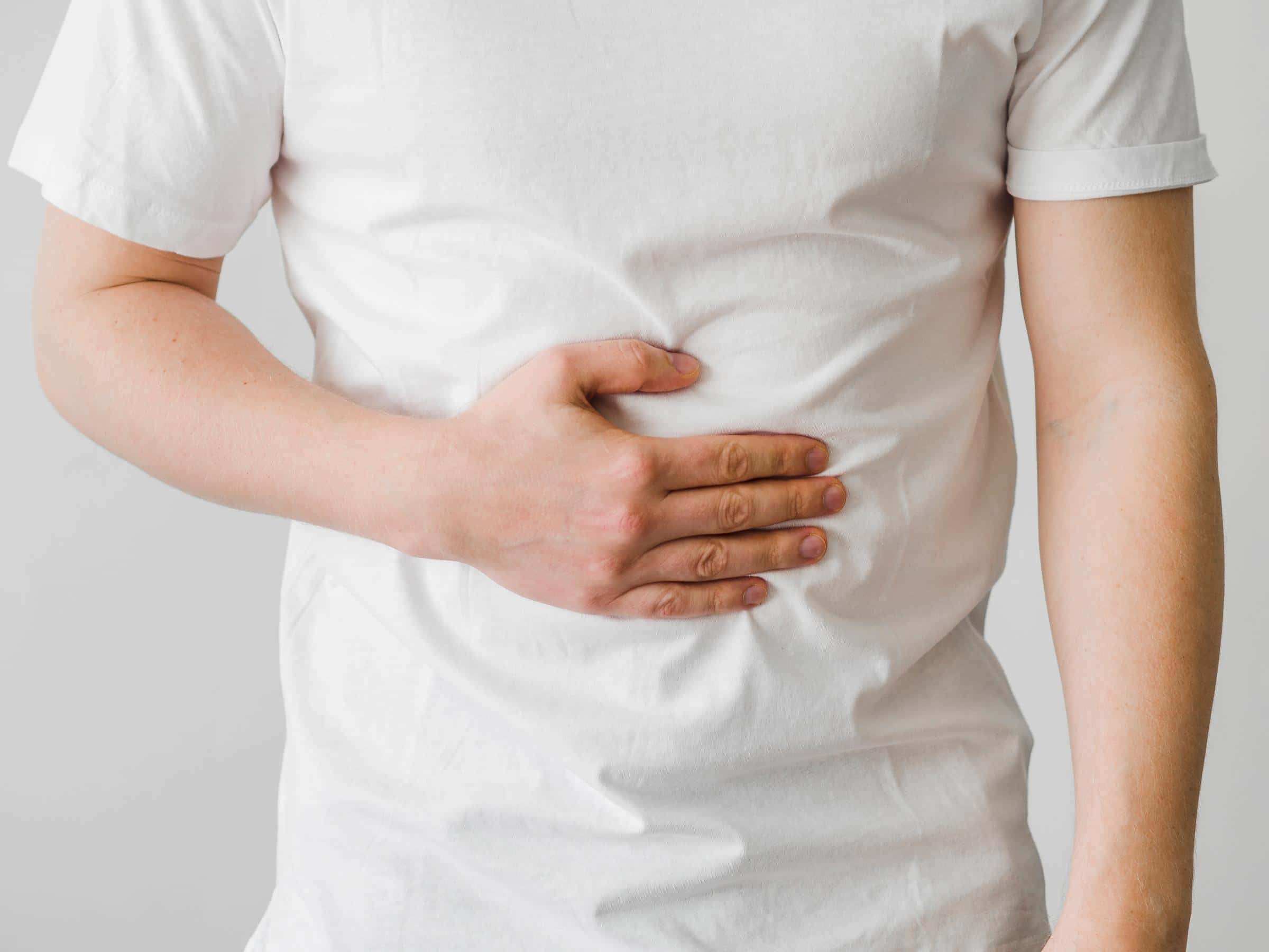 Man with his hand on his stomach