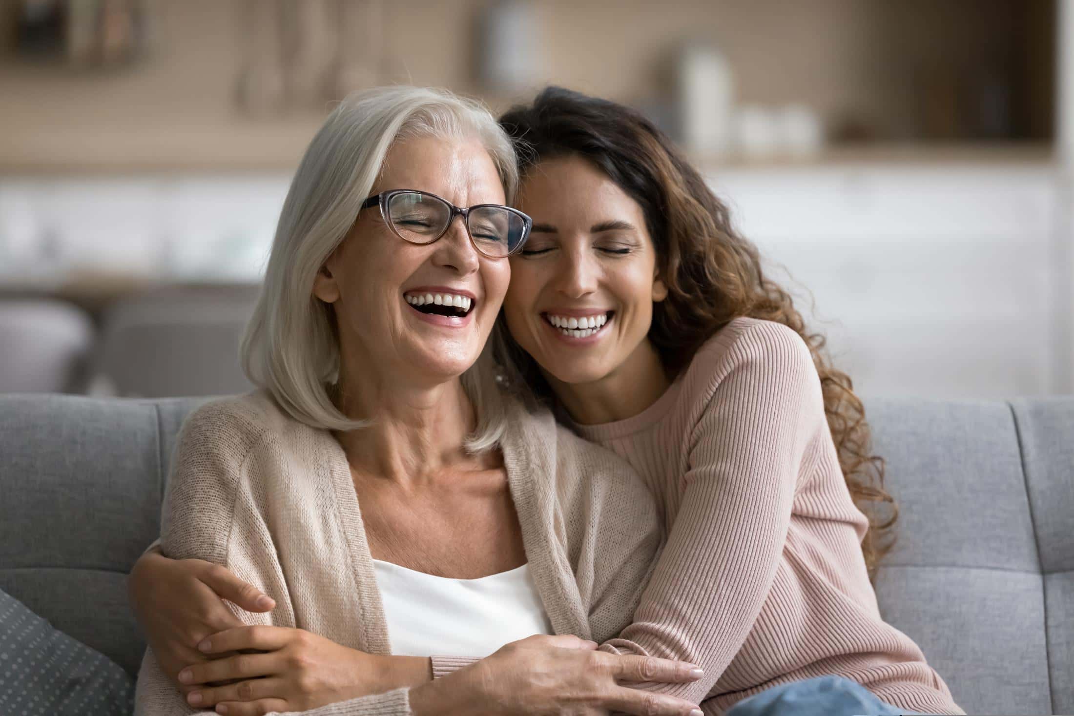 Mother and daughter laughing and hugging
