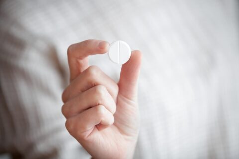 Person holding a pill