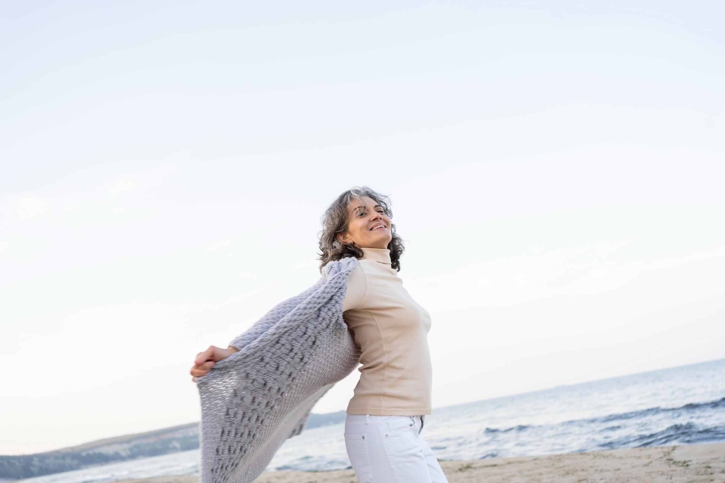 Happy middle-aged woman at the beach