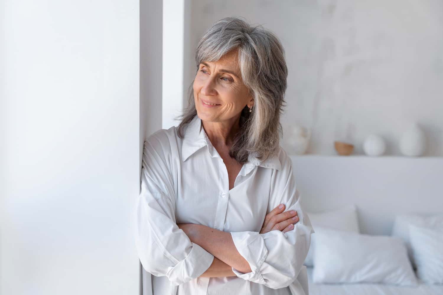Middle aged woman looking at the window