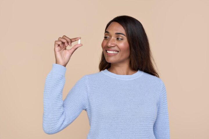 Woman holding a pill