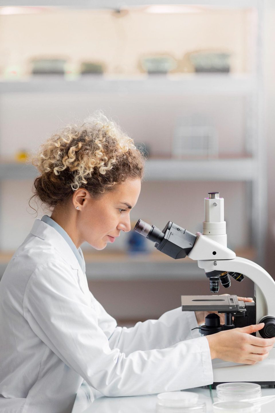 Investigator with a microscope in the lab